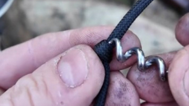Using a corkscrew bottle opener to untie a knot