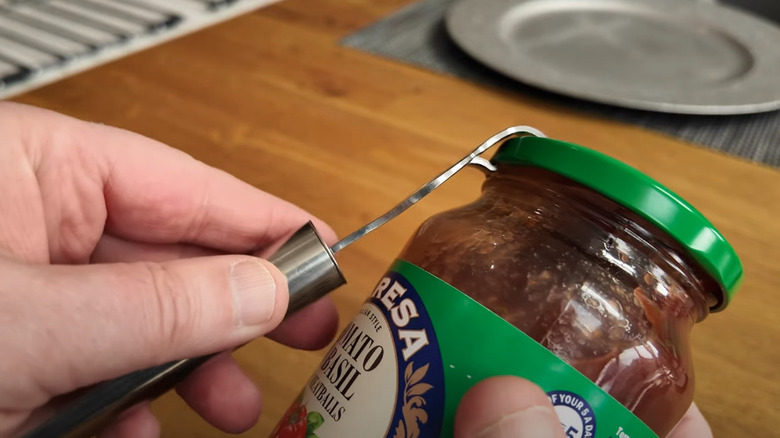 Opening a jar lid with a bottle opener