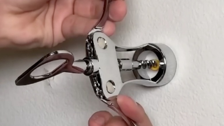 Using a wine bottle opener to remove a drywall anchor