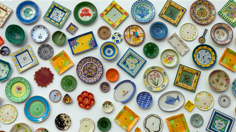 mismatched china plates hanging on a wall