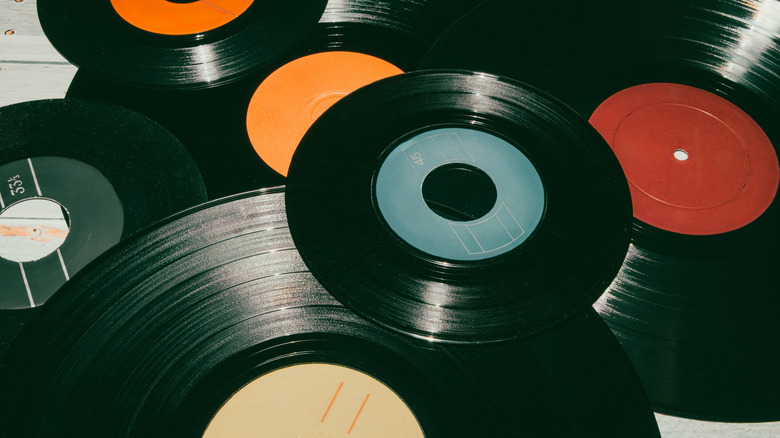 A stack of old vinyl records without sleeves