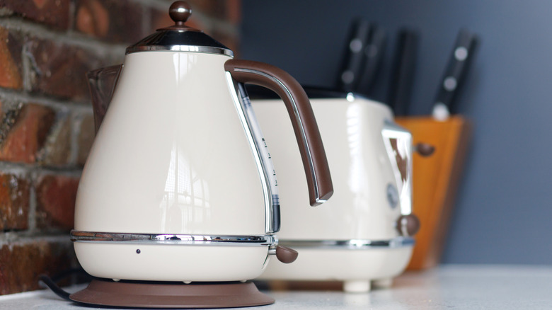 white and brown kettle and matching toaster