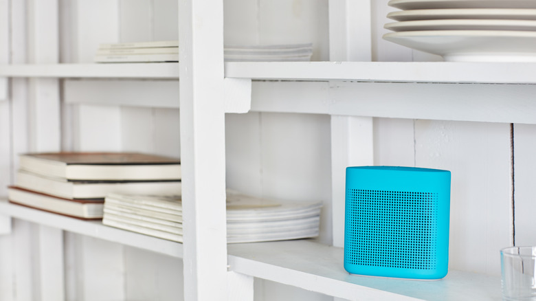 white shelves with blue wireless speaker