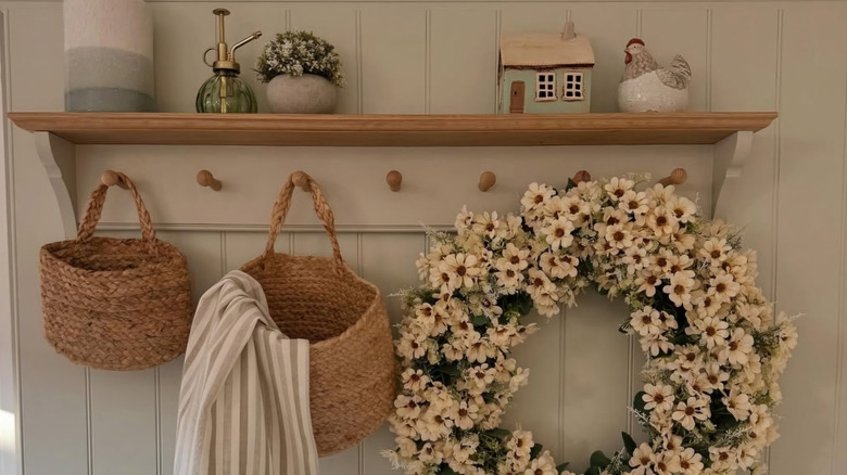 Kitchen peg shelf with decor items and hanging basket