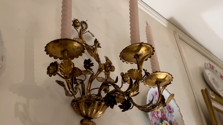 Closeup of a gilded gold candle sconce