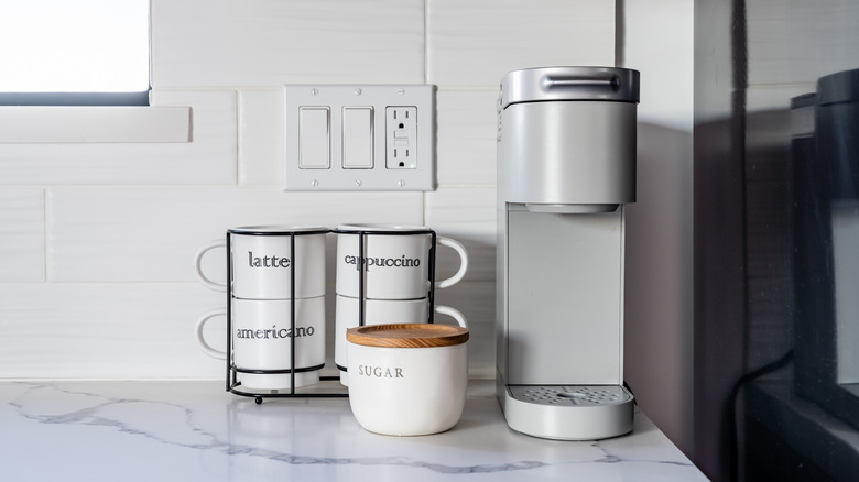 Fresh cup of coffee in a glass mug on a single serve coffee maker
