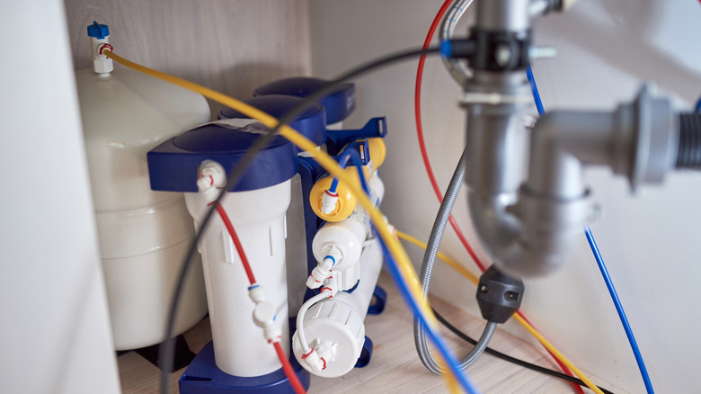 A reverse osmosis water filter system under a sink.