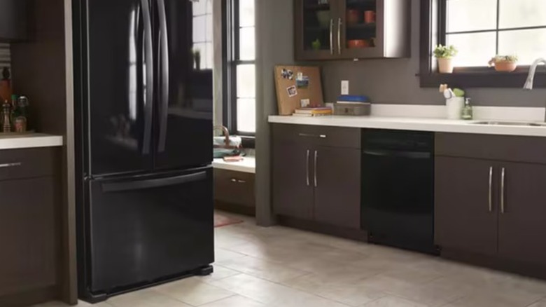 A modern kitchen with a black refrigerator and dishwasher