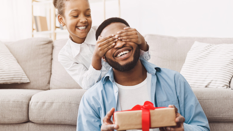 daughter giving dad present