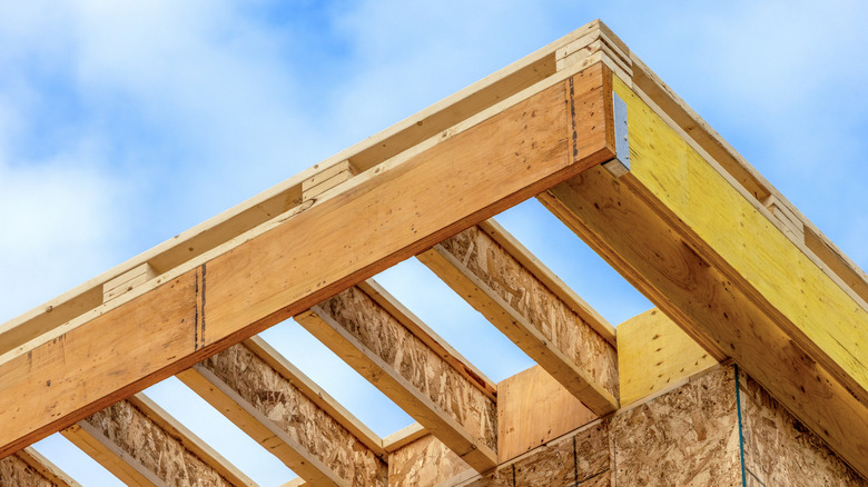 The corner of a roof under construction, with engineered wood joists and Laminated Veneer Lumber (LVL) headers