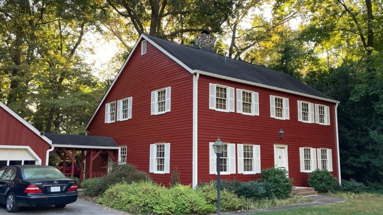 Scandinavian style red home with white windows and trims