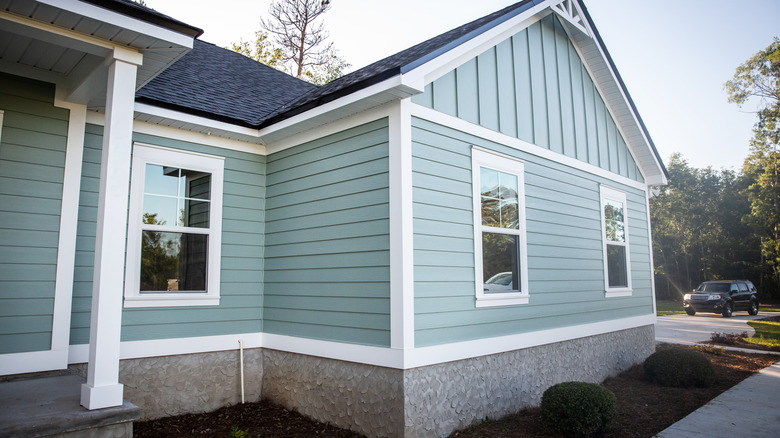Dusty blue home with white trims and windows