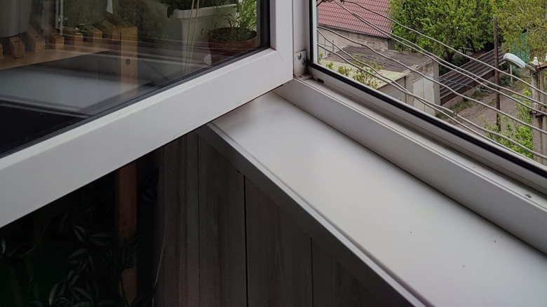 An open window revealing a cloud day outside.
