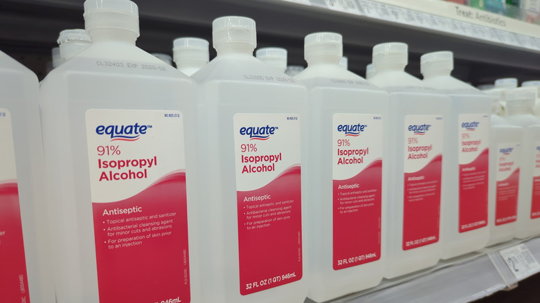 Isopropyl rubbing alcohol bottles on store shelf at Walmart.