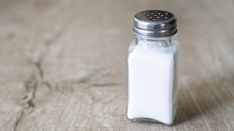 Table salt in clear glass salt shaker