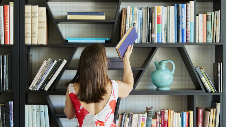 Bookshelf with a blue ceramic vase