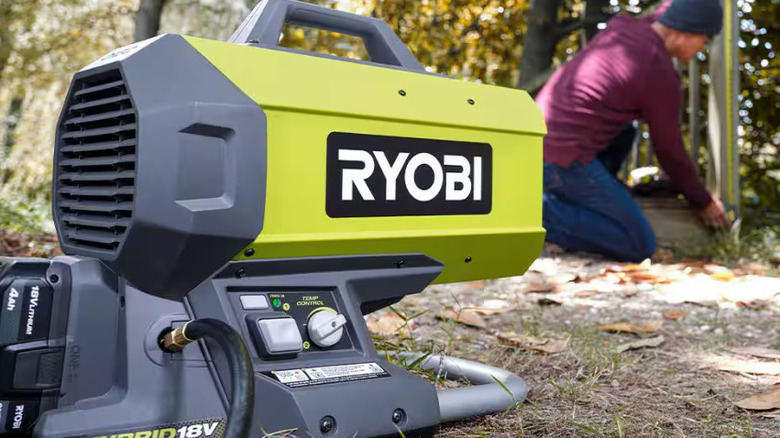The Ryobi Propane Heater blowing towards someone working outdoors.