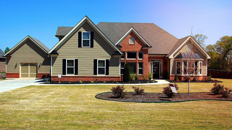 brick house with sage paneling