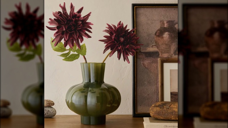 Purple dahlias in a green vase