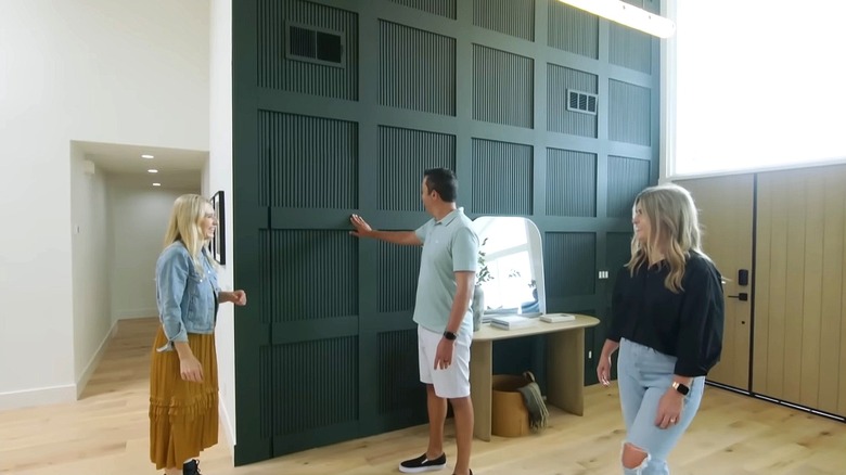 HGTV designer Jasmine Roth opens a secret door to a closet in modern home.