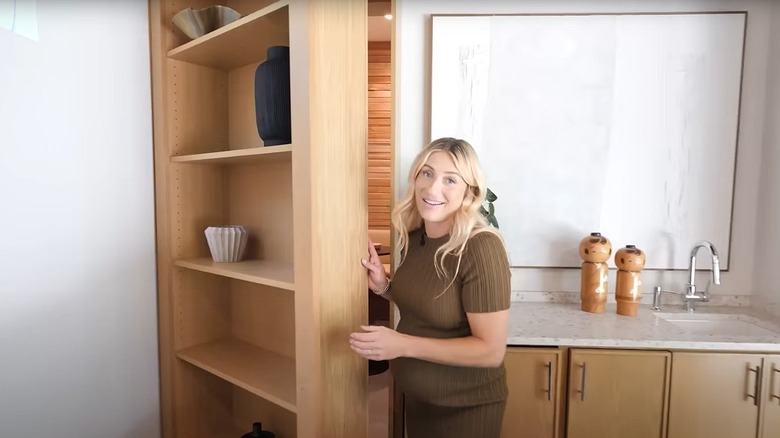 Celebrity designer Jasmine Roth shows off a secret room behind a bookshelf in her home.