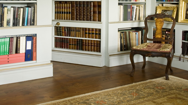 A bookcase reveals a hidden door into another room.