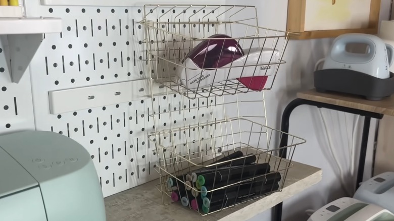 Wire tray organizer holding tape dispenser and markers