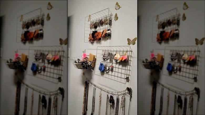Wire trays hung on wall with multiple earrings