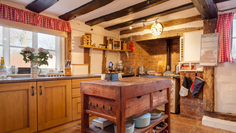 Cottage with stove alcove set in brick with storage shelves and rails on either side