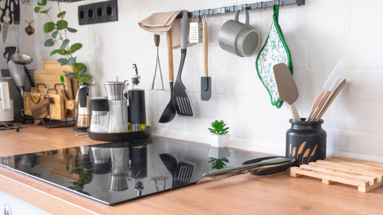 Utensils hanging behind range