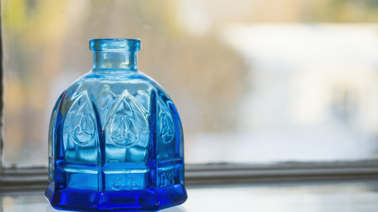 Blue bottle on window sill