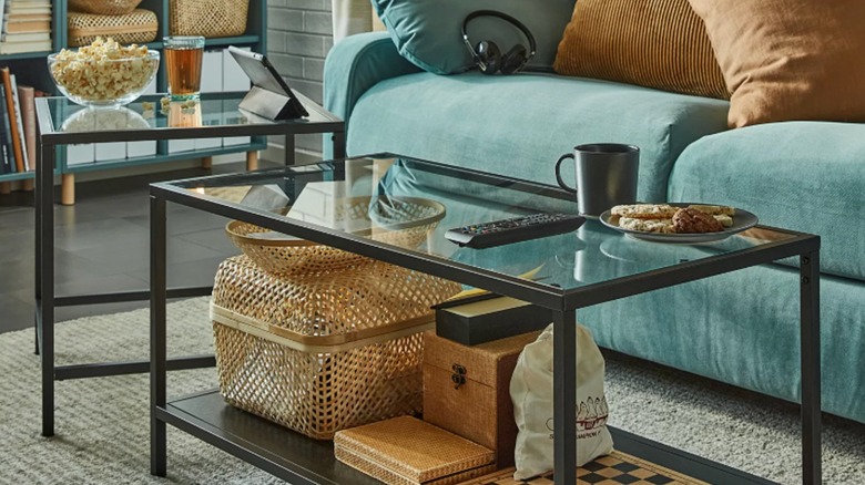 nesting glass and black metal coffee tables in a living room