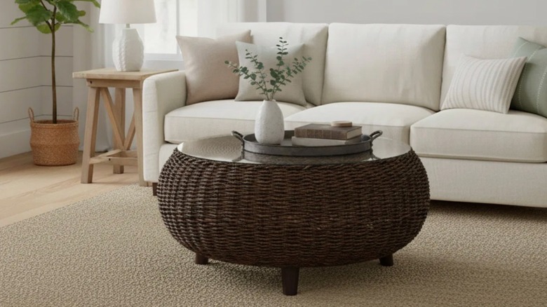dark round rattan coffee table with a glass top