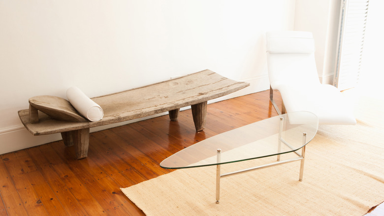 oval three-legged glass table in a living room
