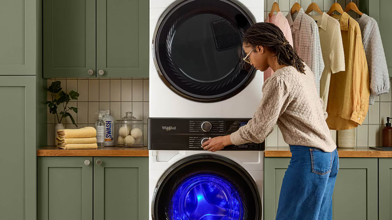 A person using Whirlpool washer and dryer
