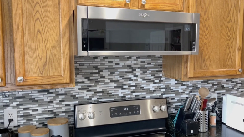 A kitchen fitted with Whirlpool's 1.1-cubic-feet Low Profile Over-the-Range Microwave