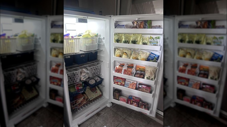 Whirlpool's 15.7-cubic-feet Upright Freezer with door open, stocked with food