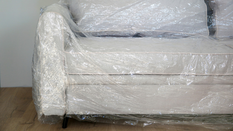 Couch covered in plastic