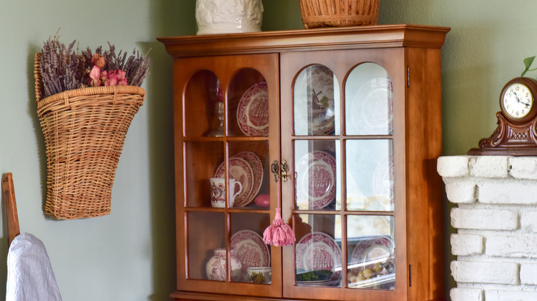 A large wooden china hutch in a dining room.