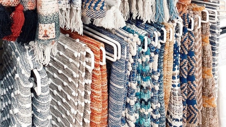 A collection of rugs displayed at a T.J. Maxx store