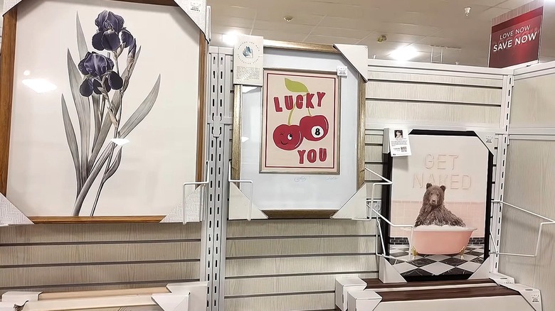 Three frames with graphic prints displayed in a store.