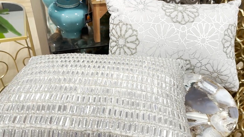 Two grey and white pillows with glitter details