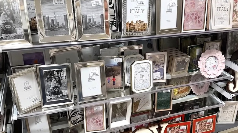 A display of picture frames on shelves in a store.