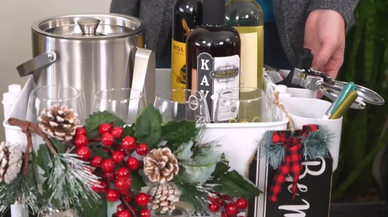 Holiday-themed bar cart featuring wine bottles, glasses, and ice bucket