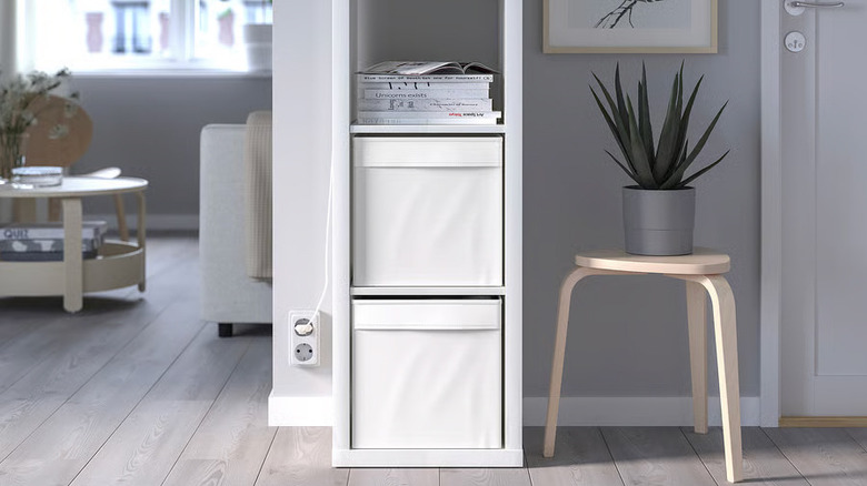 Two white DRÖNA storage boxes from IKEA are displayed in a KALLAX shelving unit