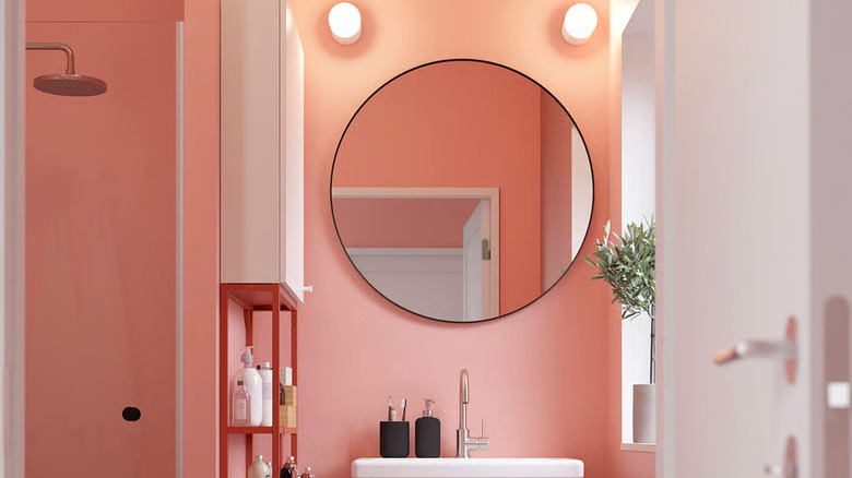 A black LINDBYN mirror from IKEA hangs above a bathroom sink