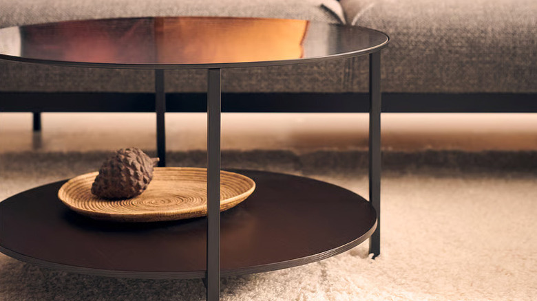 A VITTSJÖ coffee table from IKEA sits in front of a gray sofa
