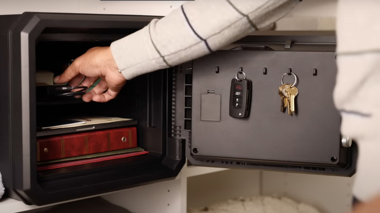 man putting keepsakes in safe