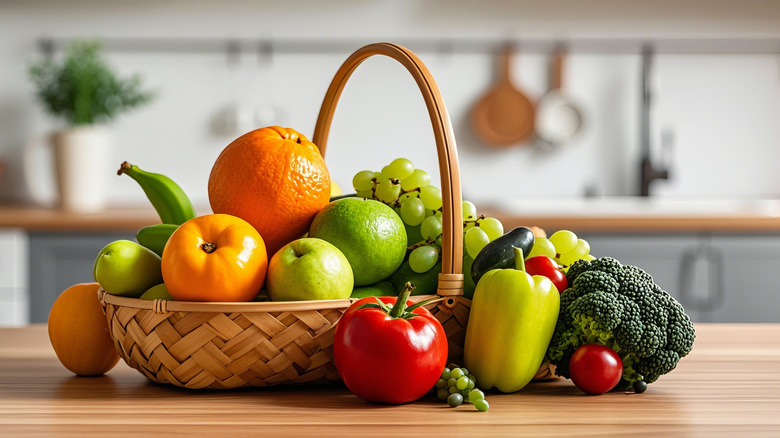 fresh fruits and vegetables in a wooden basket on a table in a modern kitchen