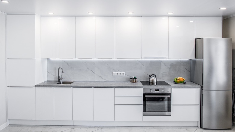 All-white kitchen and silver appliances
